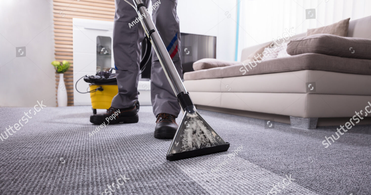 stock-photo-low-section-of-a-person-cleaning-the-carpet-with-vacuum-cleaner-in-living-room-1079107034
